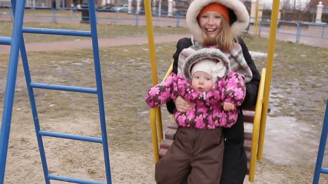 Girls ride on swing