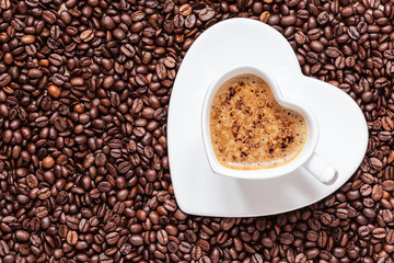 white coffee cup heart shaped with cappucino
