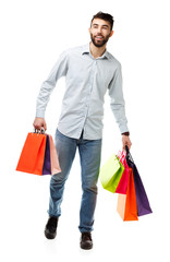 Handsome man holding shopping bags on white background