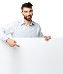 A young bearded man showing blank signboard, isolated over white