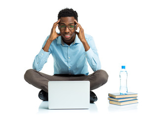 African american college student with headache sitting on white
