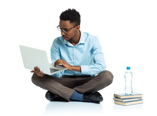African american college student sitting with laptop on white
