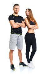 Athletic man and woman after fitness exercise on the white