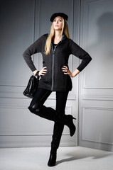 full-length fashion or casual woman holding bag posing studio