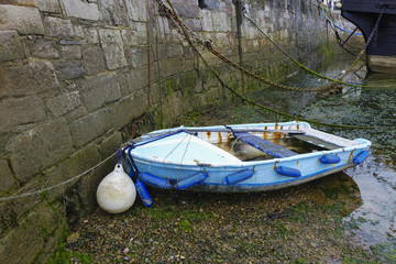 Fototapeta na wymiar Blue boat chains empty harbor harbour Brixham Devon England UK
