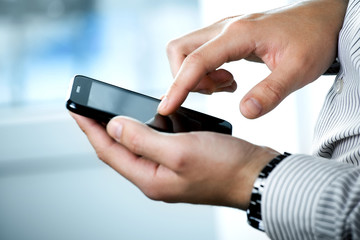 Close up of a man using mobile smart phone