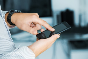 Close up of a man using mobile smart phone