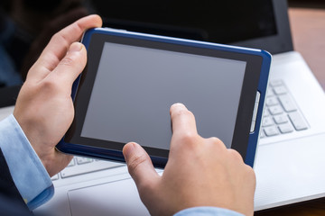 Businessman working on tablet and laptop