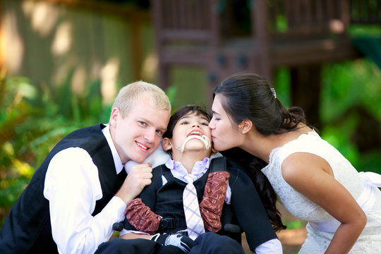 Biracial bride kissing her little brother on her wedding day. Ch