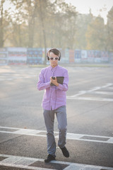 young crazy funny asian man in town outdoor lifestyle listening