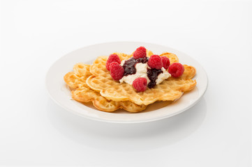 Waffle with cream, jam and raspberries