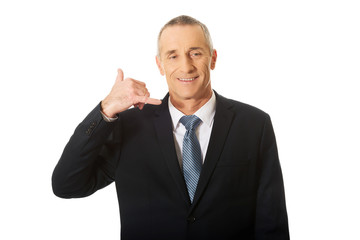 Businessman with call me gesture