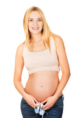 Pregnant woman with small blue shoes
