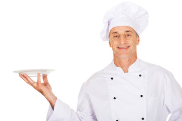 Chef holding white porcelain plate