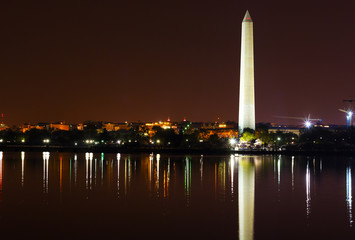 Washington Monument at night and city skyline on background