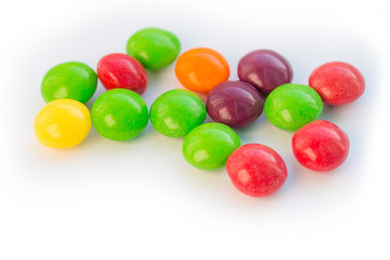 Colorful chewy dragee on a white paper.