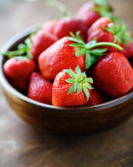 ripe strawberries in a wooden bowl