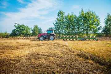 Fototapeta na wymiar agricultural processing tractor plowing field