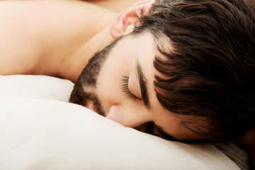 Young man sleeping in bed.