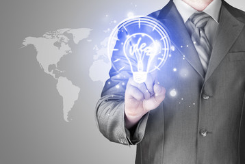 Business man touching light of idea