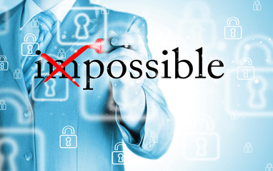 Businessman Hand turning the word Impossible into Possible with