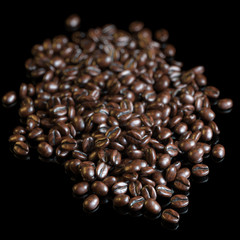 Roasted coffee beans on black background for advertising