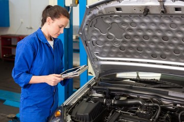 Mechanic using tablet to fix car