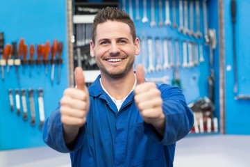 Smiling mechanic looking at camera