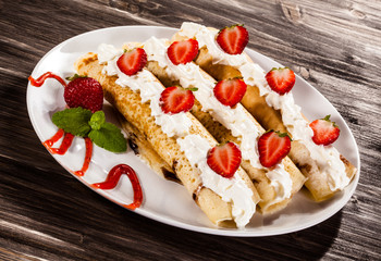 Pancakes with cream and strawberries