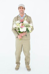 Smiling delivery man holding bouquet