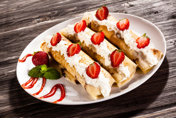 Pancakes with cream and strawberries