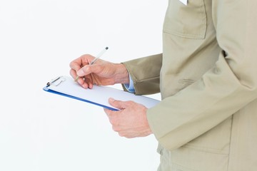 Delivery man writing on clipboard