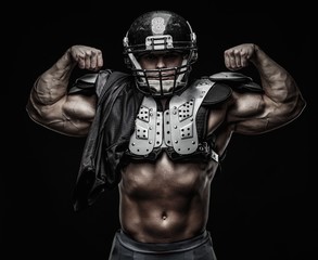 American football player wearing helmet and protective armour