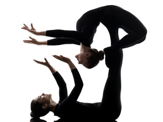 two women contortionist  exercising gymnastic yoga silhouette