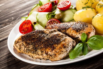 Fried chicken fillets, boiled potatoes and vegetable salad