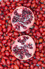 Rose-hip berries and two halves pomegranate