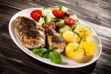 Fried chicken fillets, boiled potatoes and vegetable salad