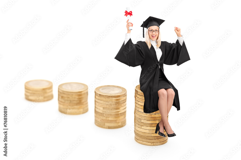 Wall mural Female graduate sitting on a pile of coins