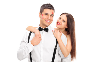 Lucky guy covered in kisses by a beautiful woman