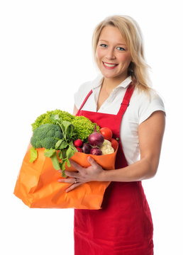 Blonde Hausfrau mit Tasche voller Gemüse
