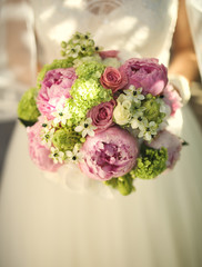Flower bouquet in bride hands.closeup