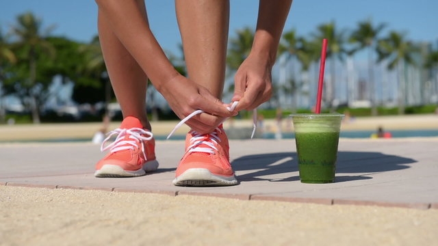 Running woman runner with green vegetable smoothie