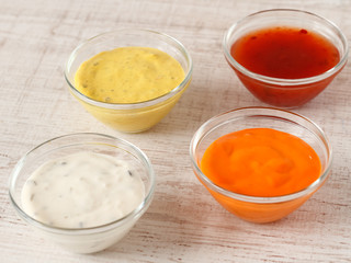 Garlic, chili, curry and cocktail sauce in small bowls