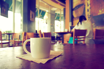 vintage color tone of  cup of coffee  on the table coffee shop