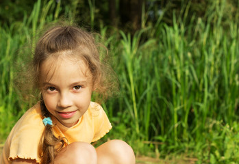 Healthy Smiling little Girl in Green Grass.