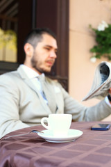 Handsome man reading a newspaper