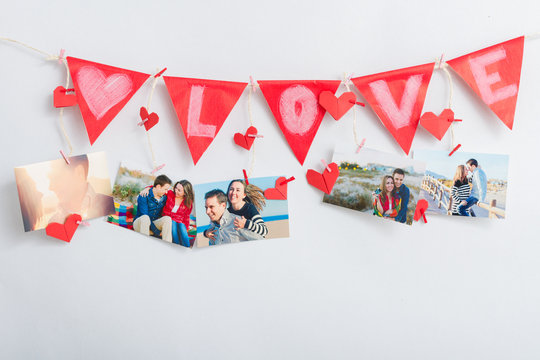 Wall with pictures and garland hanging on clothesline