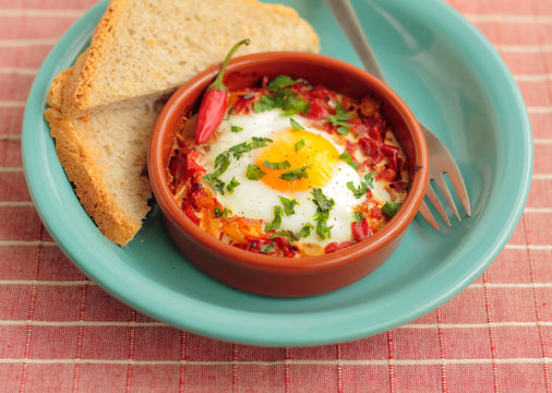 Eggs poached in tomato sauce and other vegetables