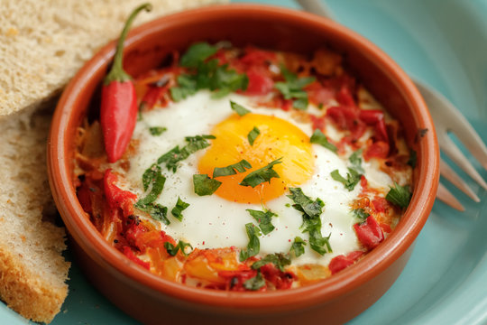 Eggs poached in tomato sauce and other vegetables