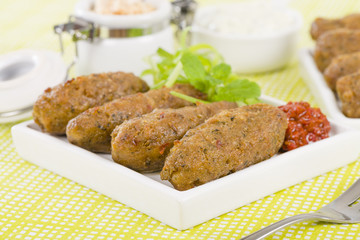 Koftas - Lamb koftas served with harissa. Middle Eastern meal!